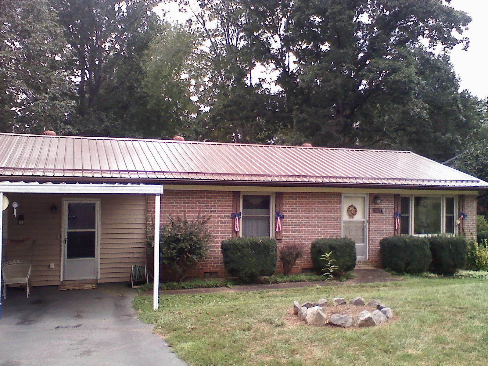 Bronze metal roof and carport on a brick ranch home — Roof Repair work by our crew in Great Barrington